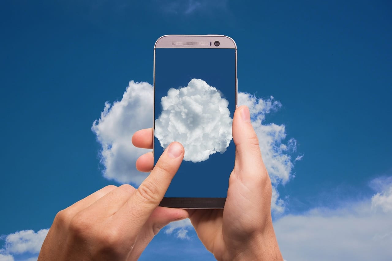 cell-phone-against-cloudy-sky-background
